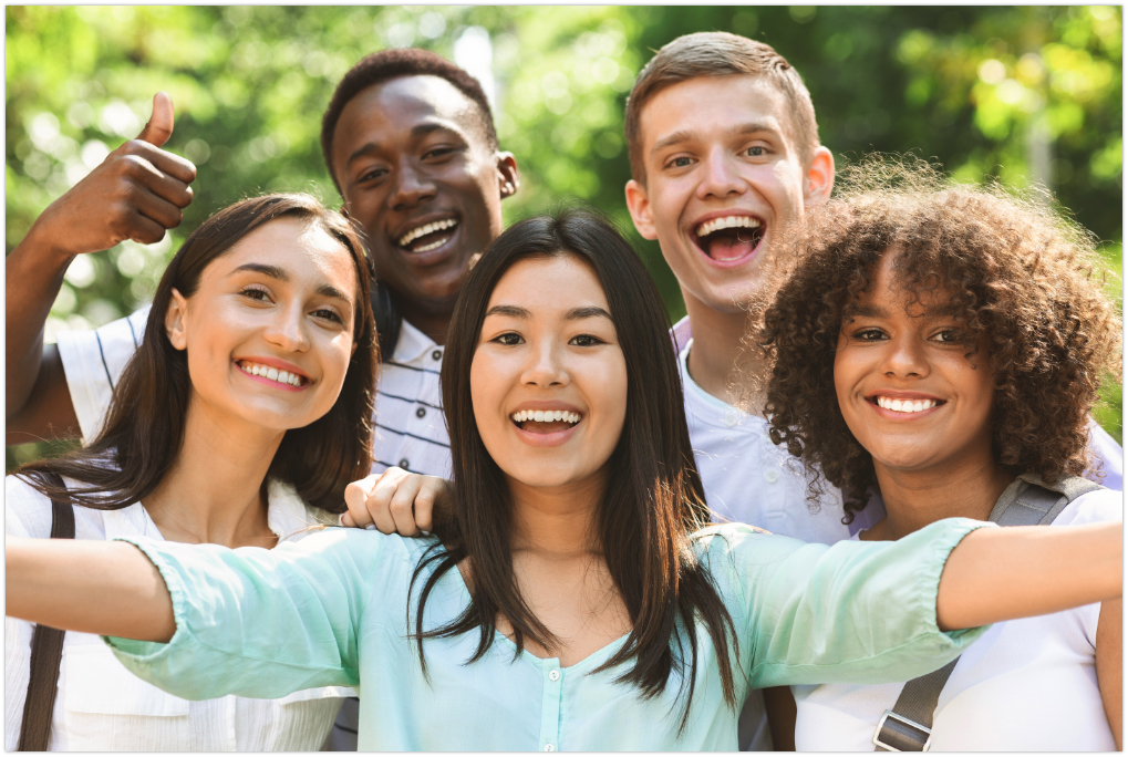 Friends smiling outside in a group shot