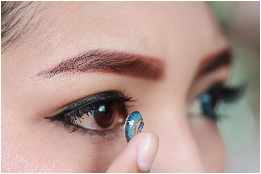 Cosplayer putting on a costume contact lens