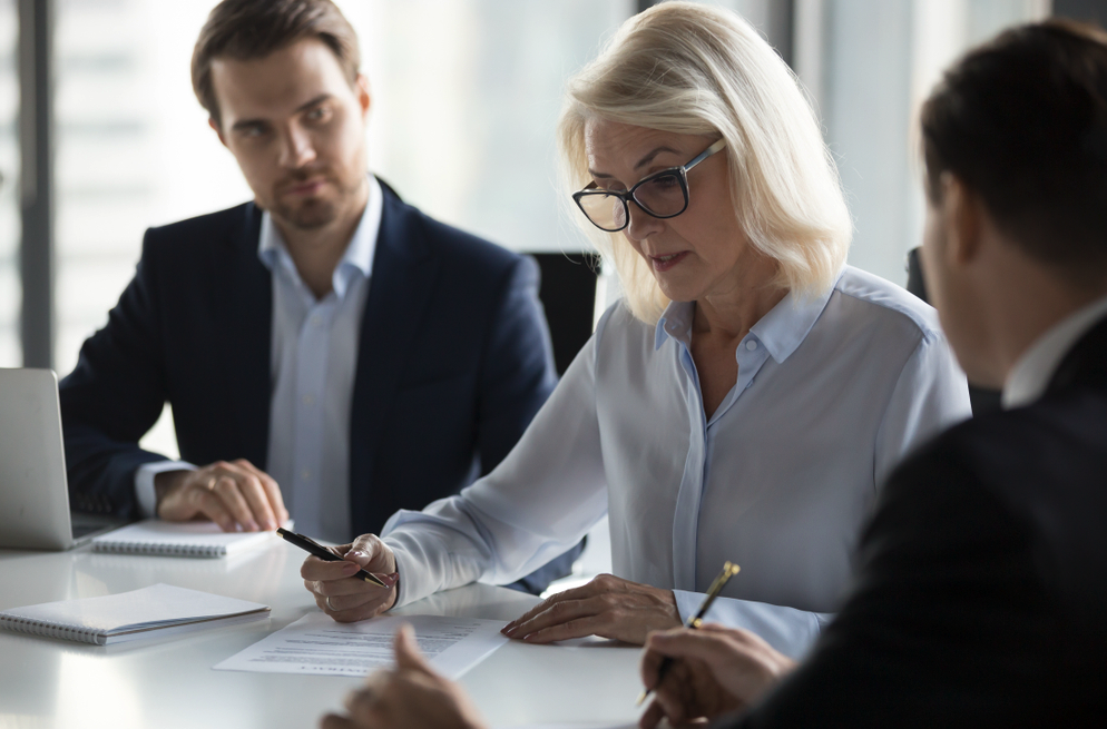 A mature woman in an office meeting